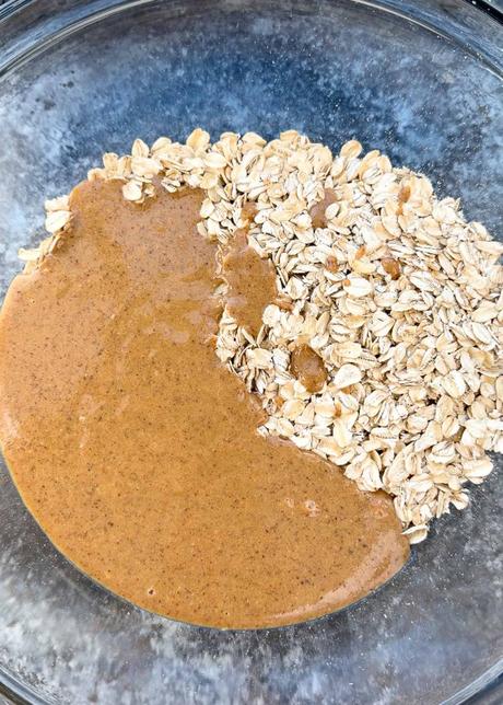 Dark Chocolate Cherry Granola Bars gluten free oats being added to mixing bowl with almond butter