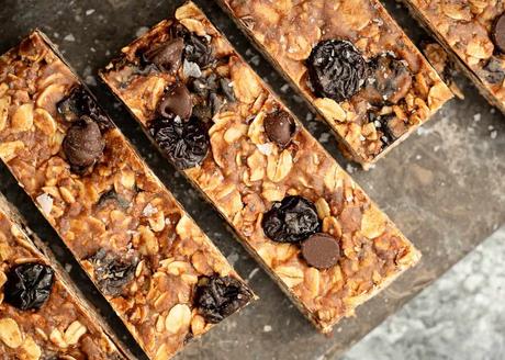 Dark Chocolate Cherry Granola Bars overhead image of 4 homemade granola bars on stone background