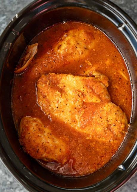 cooked chicken breasts in tinga sauce in slow cooker