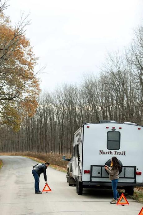 white and red bus on road during daytime, be prepared with RV roadside assistance for any emergencies that come up on your travels,