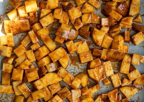 uncooked potatoes on a sheet pan