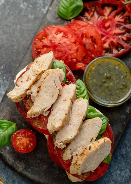 overhead image of open faced sandwich with ingredients being layered 