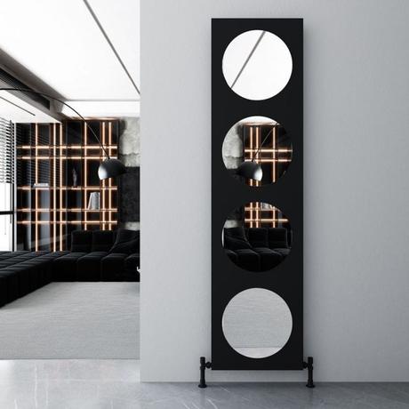 Carisa Circles black aluminum vertical mirror designer radiator on light gray wall in modern home setting