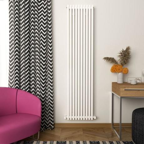 Carisa Sophia white aluminum vertical designer radiator on white wall nearby patterned curtain and purple chair