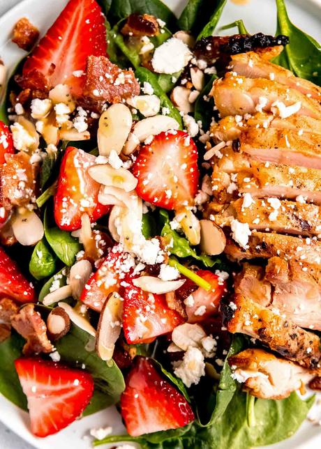 close up image of garnished strawberry spinach salad 