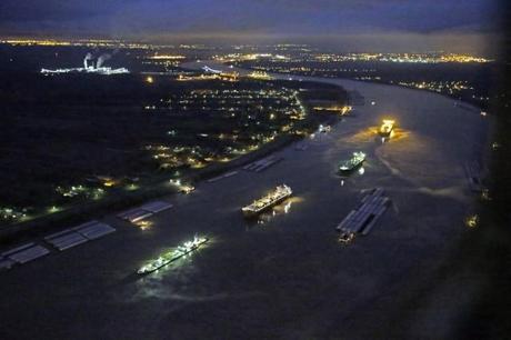 In this aerial photo, river traffic is halted along the Mississippi River between New Orleans and Vacherie, La., due to a barge leaking oil in St. James Parish, La., Sunday, Feb. 23, 2014. Credit: AP Photo/Gerald Herbert