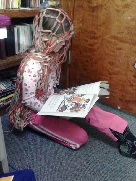 Reading a biography about the Mayo brothers in a quiet corner or Mama's office.  Why does she have a net on her head? Your guess is as good as mine but she's reading and she's happy so... yeah... we just roll with it.
