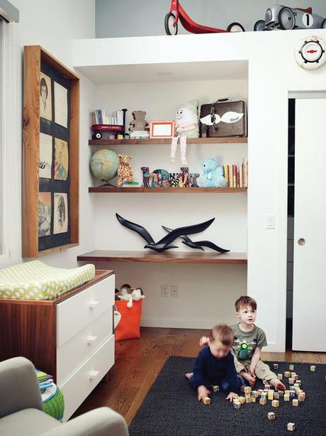Modern kids room with built-in shelves and Ducduc changing table 
