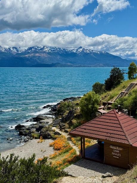Lakeside sauna and massage cabin overlooking turquoise water and snow-capped mountains along the Carretera Austral