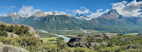 Panoramic view across a river valley to the snow-covered mountains near Villa Cerro Castillo, Chile
