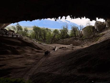 Visitors walking through the main cave at Mylodon Cave Natural Monument near Puerto Natales