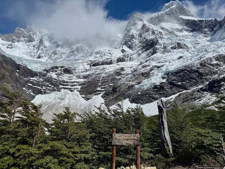 Mirador Francés lookout sign beneath glaciers and snow-covered mountains on the Torres del Paine W Trek