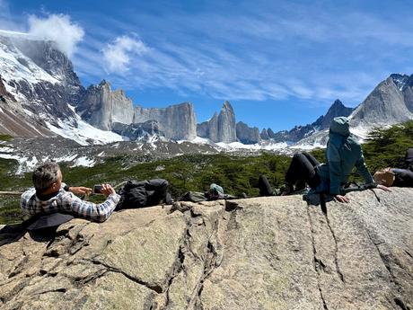 Hikers resting on rocks beneath the surrounding granite peaks at Mirador Británico in French Valley