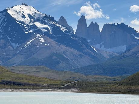 Close view of the Torres del Paine massif across the turquoise Laguna Amarga lake under clear blue skies