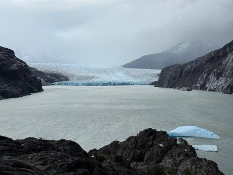 Grey Glacier flowing into Grey Lake with blue icebergs beneath overcast skies in Torres del Paine