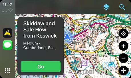 A trip preview on the CarPlay screen showing the hike Skiddaw and Sale How from Keswick with a green Go button, over Ordnance Survey mapping