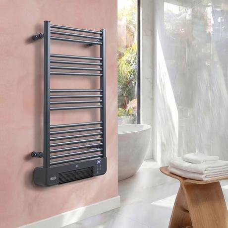 ECOSO Llora anthracite smart electric heated towel rail with fan on pink wall nearby white freestanding bathtub and white wall