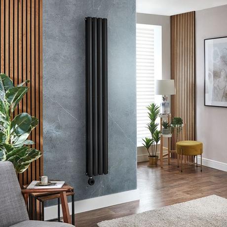 Milano Aruba black electric vertical designer radiator on blue/grey wall nearby wooden panelling