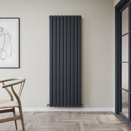 Milano Alpha black convector flat panel vertical designer radiator on light wall nearby framed picture and door frame
