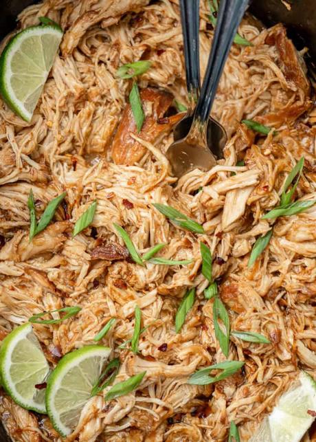 an overhead image of honey chipotle chicken shredded in a slow cooker