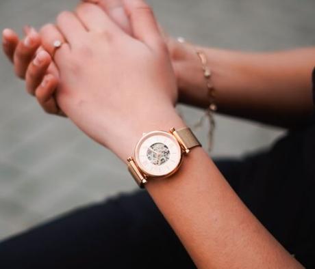 Woman’s hands wearing a rose-gold mechanical watch