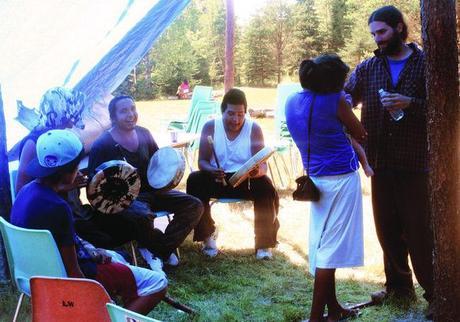 Campers at the 2013 Grassy Narrows Youth Gathering play hand drums and sing while escaping from the sweltering heat under their tarp on Aug. 20. 