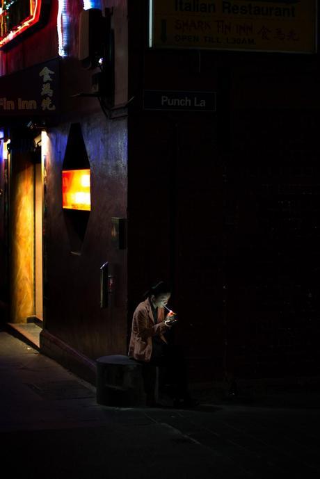 man smoking cigarette in laneway