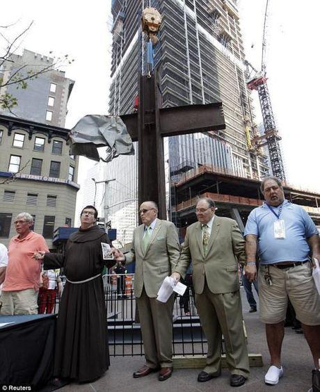 Part of history: The cross has become a symbol very closely connected to the tragic event and was featured near Ground Zero for the years that followed (pictured with former Ground Zero chaplain Rather Brian Jordan and former Mayor Rudy Giuliani around the 10th anniversary) 