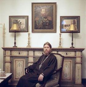 Father Tikhon in a tea room for guests at Sretensky monastery. The painting on the wall is of the Russian tsar Alexander the Third