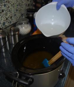 adding the lye water to the crockpots