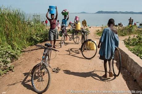 Tanzania: No Water No Life Mara River Expedition, Musoma, on Lake Victoria, local beach used for washing, laundry, swimming and collection of water taken home in buckets carried on the head and on bicycles