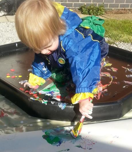 Little Miss A gets really messy with outdoor painting!