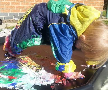 Little Miss A gets really messy with outdoor painting!