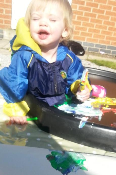 Little Miss A gets really messy with outdoor painting!