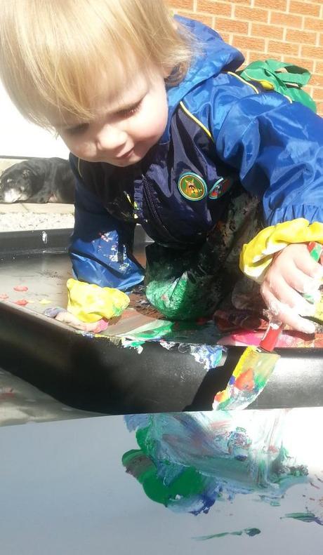 Little Miss A gets really messy with outdoor painting!