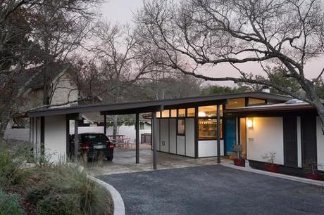 the renovated exterior of the home featuring a custom teal door 