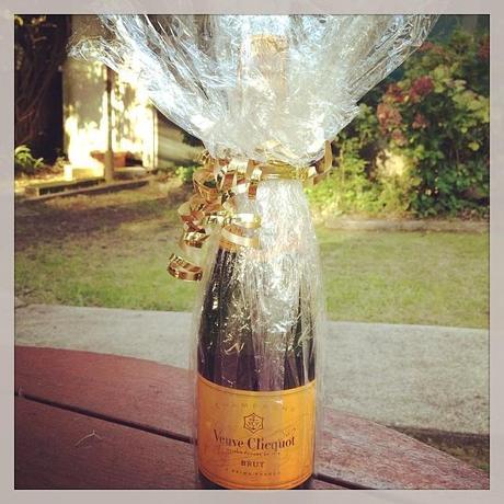 The wonderful bottle of  Veuve Clicquot photographed in my backyard. Now it is icy cold in my fridge!