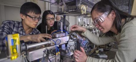 Jun Wang (on the right) with members of her research team: Jiajun Wang and Karen Chen prepare a sample for study at NSLS beamline X8C