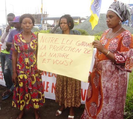 Women against oil exploration hold poster, 