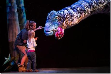 Aimee Louisanne with Titanosaur in Erths Dinosaur Zoo Live, Broadway in Chicago