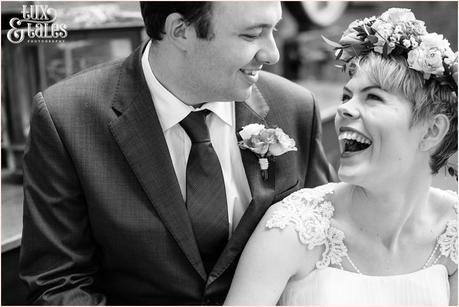 Happy bohemian bride laughs with new husband