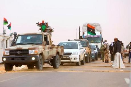 Heavily armed vehicles belonging to the military council of the self-declared autonomous region of Cyrenaica, which are deployed to protect oil ports, drive past at a checkpoint, near the east of the city of Sirte March 14, 2014. Former Libyan prime minister Ali Zeidan has fled to Europe after parliament voted him out of office on Tuesday over his failure to stop rebels exporting oil independently in a brazen challenge to the nation's fragile unity. The standoff over control of oil exports threatens to deepen dangerous regional and tribal faultlines in Libya where rival militias with powerbases in the east and west back competing political factions in the transitional government. Picture taken March 14, 2014.  REUTERS/Stringer (LIBYA - Tags: CIVIL UNREST POLITICS ENERGY) - RTR3H6EP