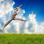 young sporty woman runing and jumping on meadow