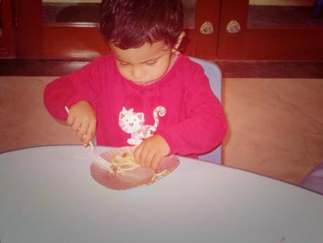 Trying to maneuver his forkful of spaghetti