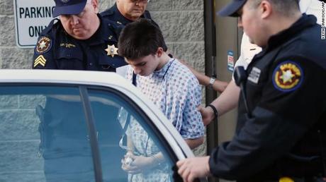 Accused attacker Alex Hribal, 16, is escorted from a district magistrate after he was arraigned as an adult on April 9. He faces four counts of attempted homicide, 21 counts of aggravated assault and one count of possession of a weapon on school grounds, according to a criminal complaint made public.