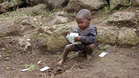 Batwa boy playing cards, Mgahinga, Uganda