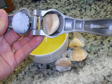 Then, I prepared garlic infused olive oil.  I started by using my handy dandy Pampered Chef Garlic Press for my garlic.  I hate mincing garlic, and this makes it so easy!