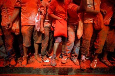 Revellers throw vermilion powder at each other during the Sindur Jatra festival