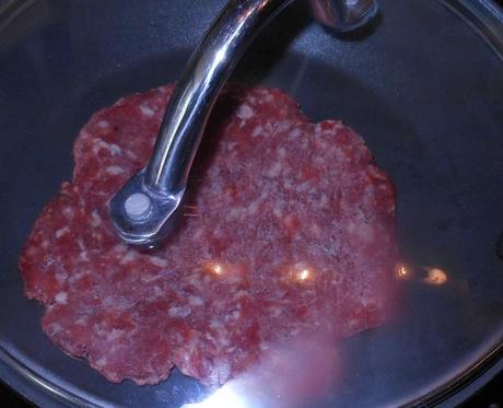 I put the patty in the preheated skillet and put a lid on the pan to allow the patty to cook evenly.