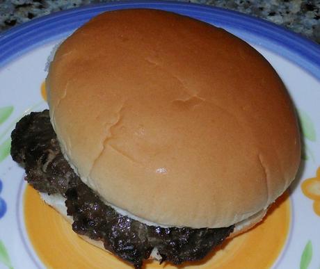 Cooked hamburger patties in a hamburger bun.